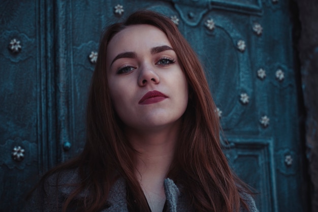 Pretty young woman at the door. Closeup shot