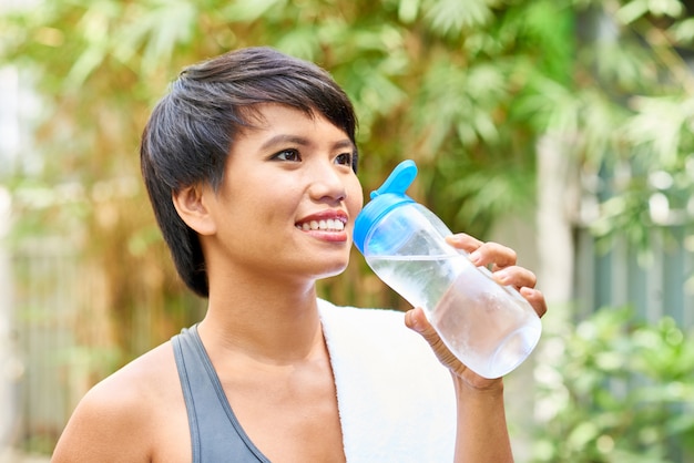 かなり若い女性は水を飲む