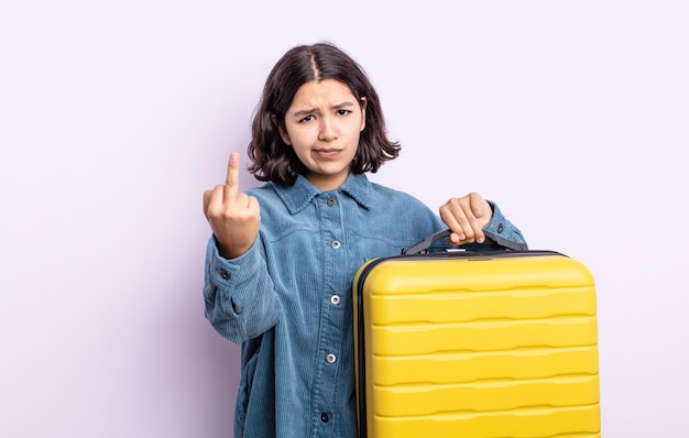 Pretty young woman feeling angry annoyed rebellious and aggressive travel case concept