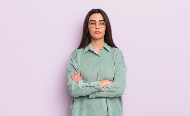 Pretty young woman feeling displeased and disappointed looking serious annoyed and angry with crossed arms