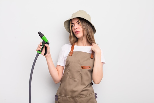 Pretty young woman feeling stressed anxious tired and frustrated gardener watering concept