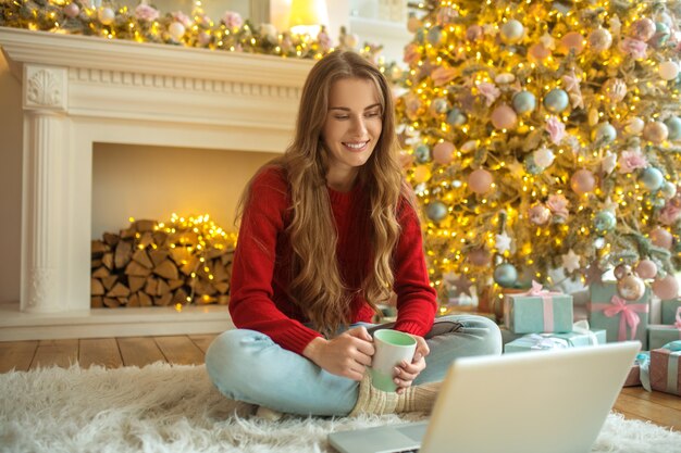 Pretty young woman having an online date and feeling happy