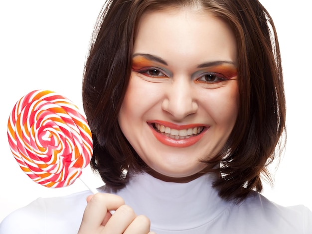 Pretty young woman holding lolly pop