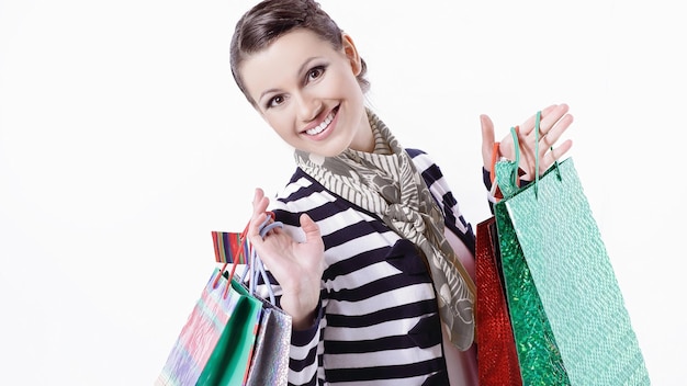 Pretty young woman holding shopping bags with purchases