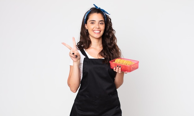 Pretty young woman holding a tupperware