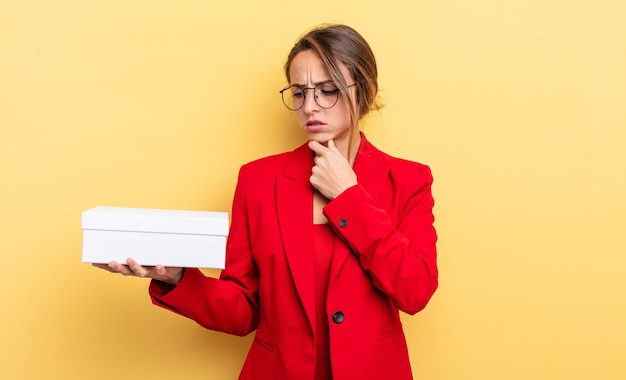 Pretty young woman holding a white box