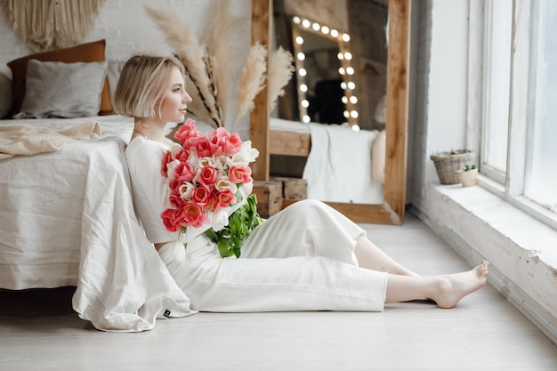 pretty young woman at home with flpwers