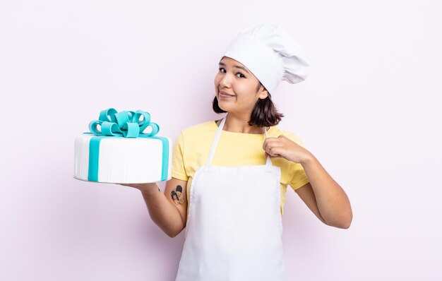 Pretty young woman looking arrogant, successful, positive and proud. chef cooking a cake