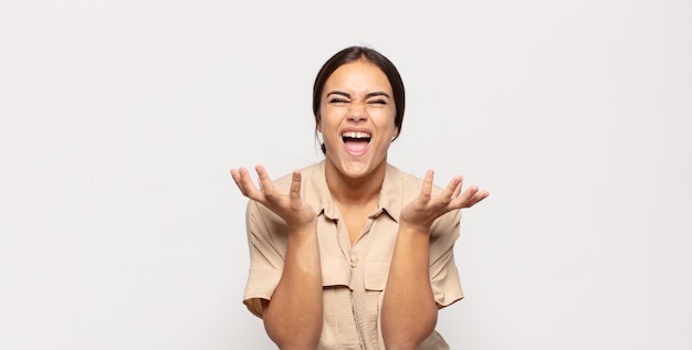 Pretty young woman looking desperate and frustrated, stressed, unhappy and annoyed, shouting and screaming