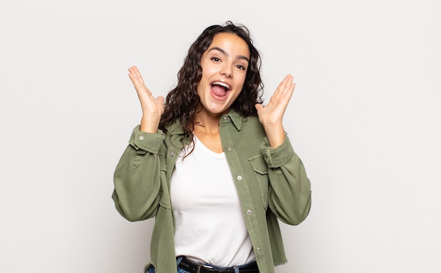 Pretty young woman looking happy and excited