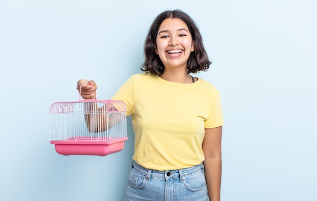 Pretty young woman looking happy and pleasantly surprised. pet cage concept