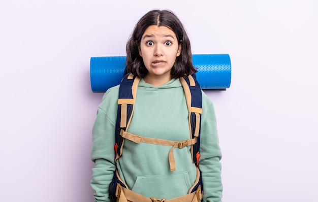 Pretty young woman looking puzzled and confused. hiking concept