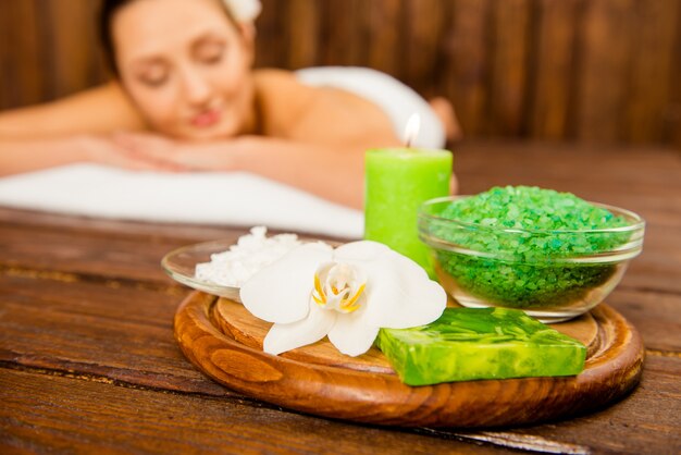 Pretty young woman lying in sauna and relaxing