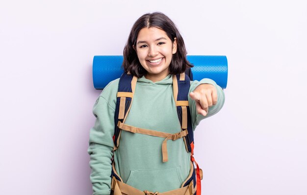 Pretty young woman pointing at camera choosing you. hiking concept