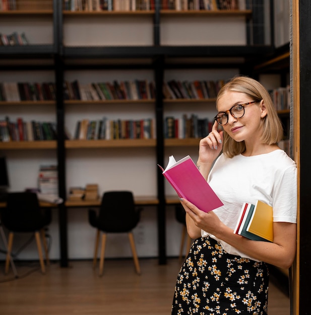 Pretty young woman posing at the library