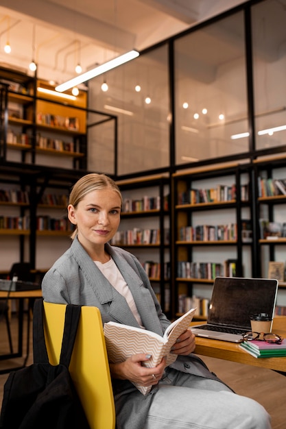 Pretty young woman posing at the library