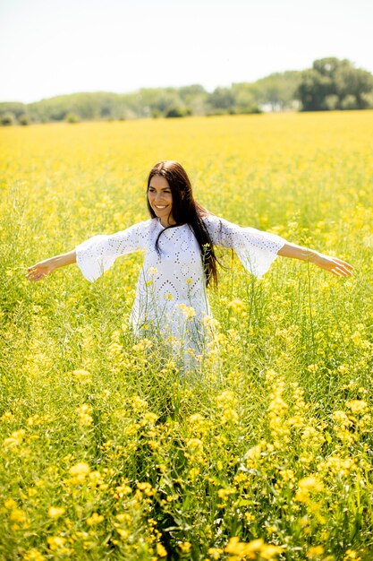 Pretty young woman in the rapeseed field