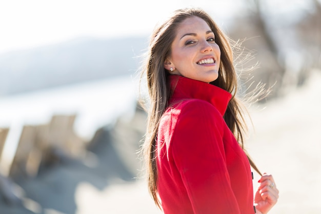 Pretty young woman in red coat