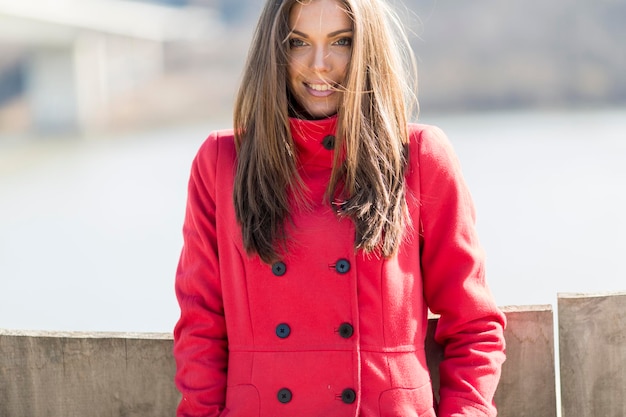 Pretty young woman in red coat