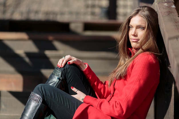 Pretty young woman in red coat