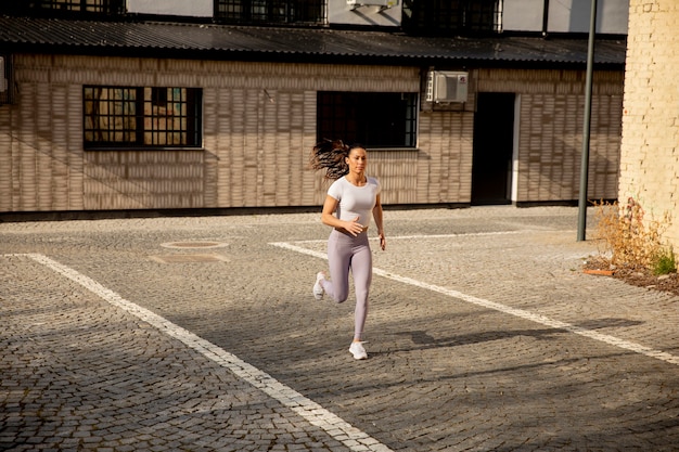 Pretty young woman running on the street