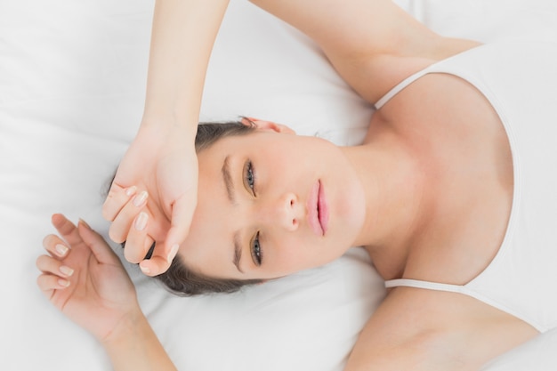 Pretty young woman sleeping in bed