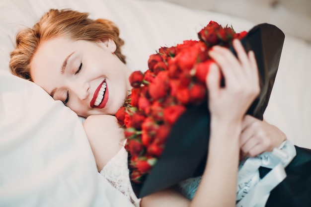 Pretty young woman smiling and flowers bouquet