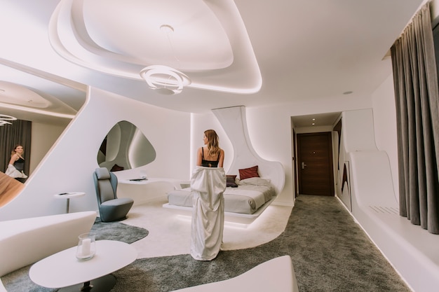 pretty young woman standing in the modern apartment