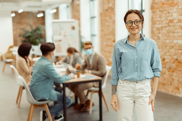 Pretty young woman standing in the office