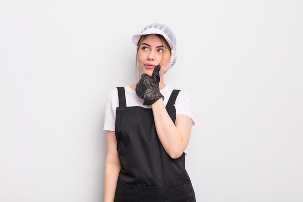 pretty young woman thinking, feeling doubtful and confused. fishmonger concept