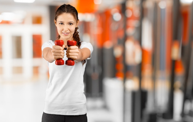 Pretty young woman training in the gym