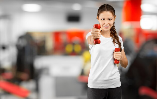 Pretty young woman training in the gym