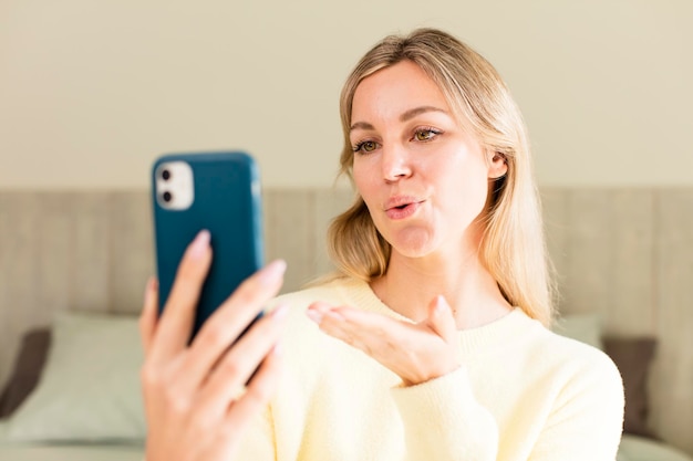 Pretty young woman using a smartphone house interior design