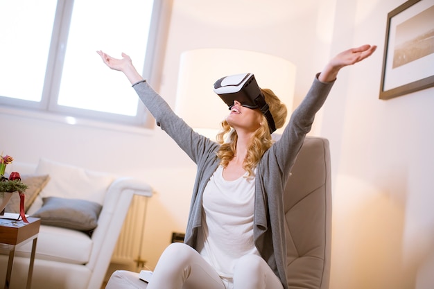 Pretty young woman wearing virtual reality goggles