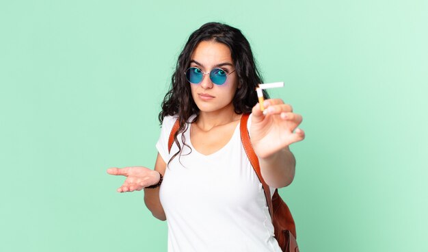 Pretty young woman with a broken cigar. no smoking concept