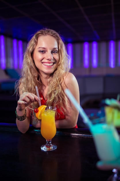 Pretty young woman with cocktail nightclub