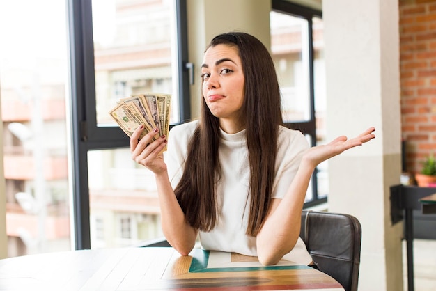 Pretty young woman with dollar bills savings concept house interior design