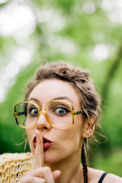 Pretty young woman with eyeglasses in the forest