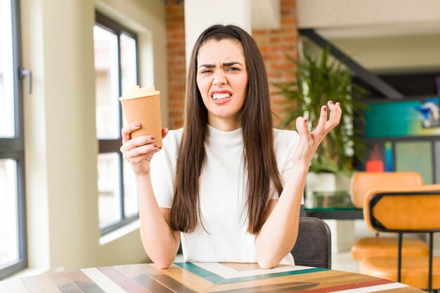 Pretty young woman with a hot coffee at home house interior design