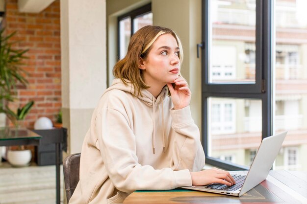 Pretty young woman with a laptop working at home house interior design