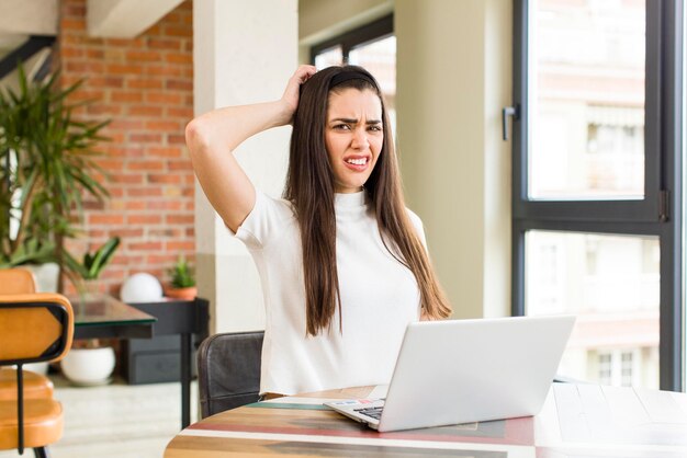 Pretty young woman with a laptop working at home house interior design