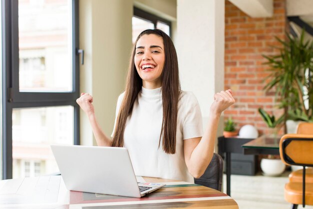 Pretty young woman with a laptop working at home house interior design