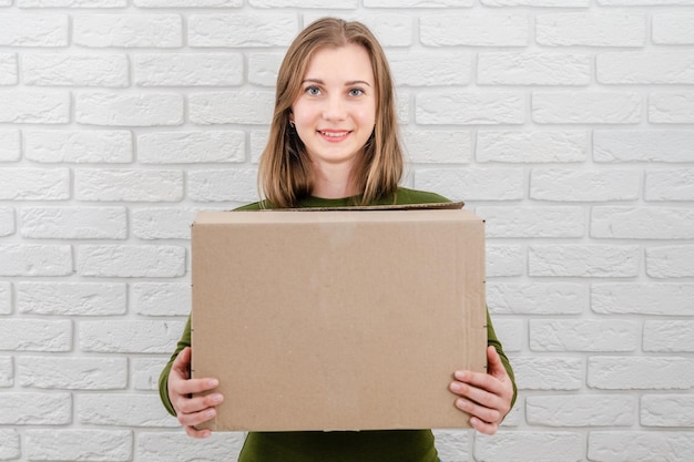 Pretty young woman with parcel box Delivering a parcel