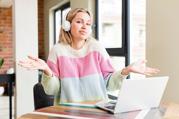 Pretty young woman working at home with a laptop house interior design