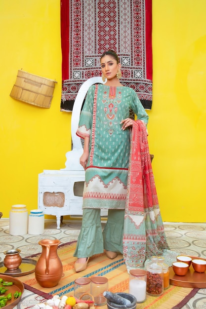 Pretty Young Women Showing Her Traditional Dress on Yellow Background