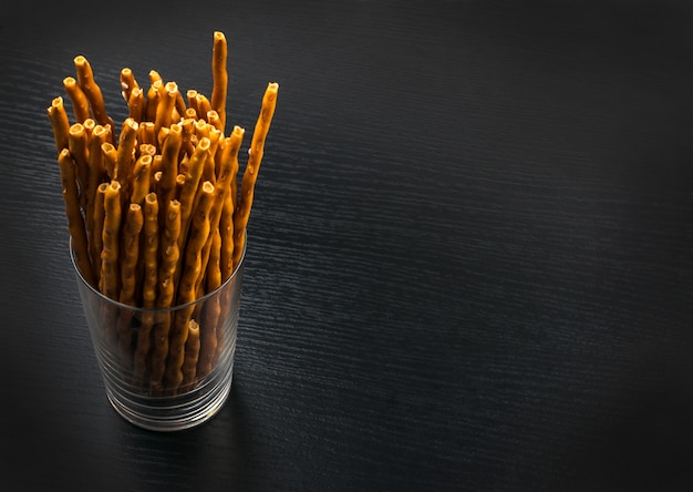 Pretzel with sesame on black background