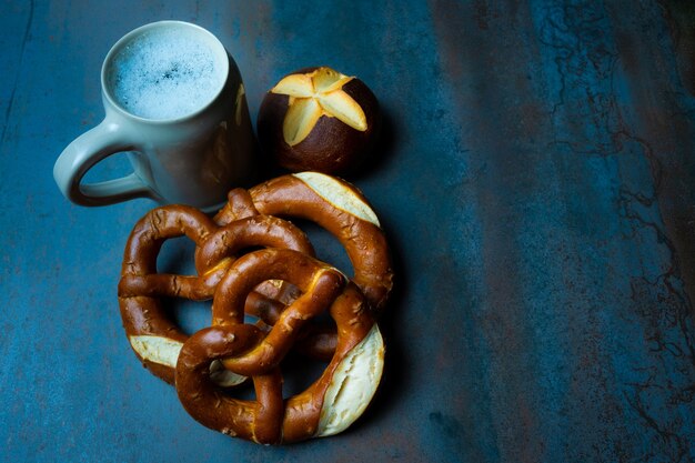 pretzels and beer jar oktoberfest dark food style textured background