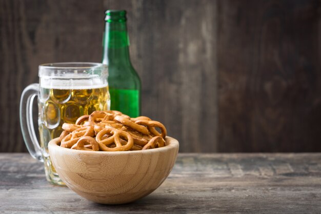 Pretzels and beer on wooden table copy space