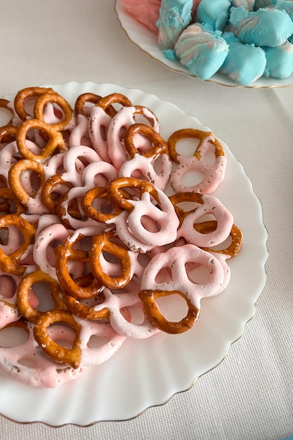 Pretzels in pink glaze on the table at the gender party