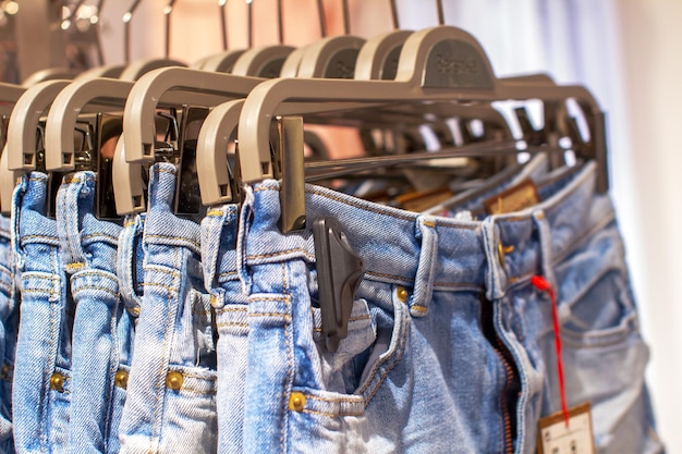 Preview jeans hanging on a hanger in the store